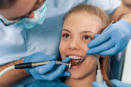 Dentist examining a patient in local dentist office