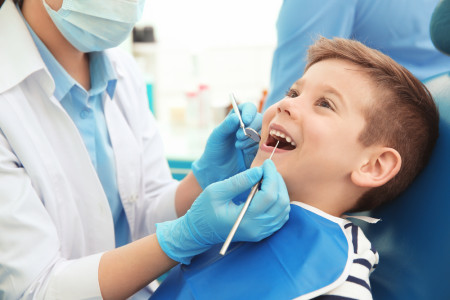 Dentist examining teeth in clinic