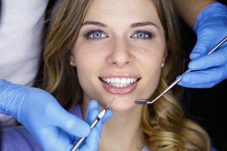 examining a patient's teeth