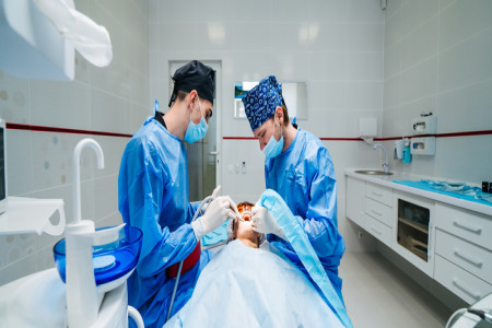 local dentists examine patient's teeth
