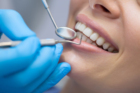 247 Dentist examining a patient teeth