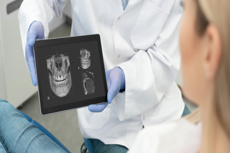 Dentist showing teeth x-ray