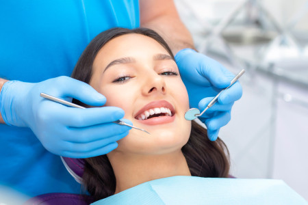 dentist examines the patients teeth