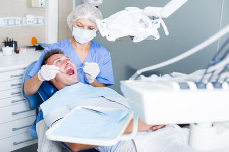 dentist treating young patient in dental office