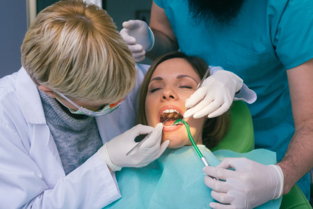 dentists examining woman's teeth