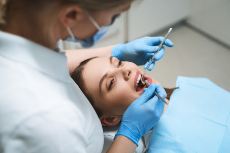 lady is lying in dental chair