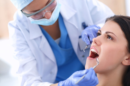 local dentist checking patient teeth