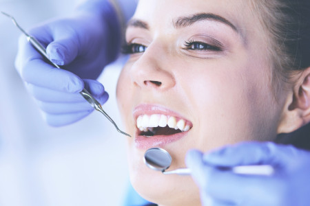 open mouth examining dental inspection at dentist office