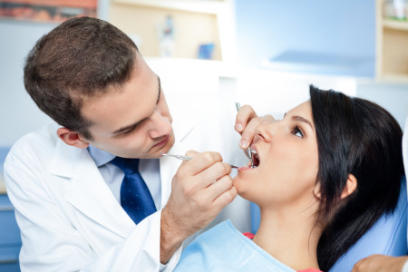 patient with dentist and assistant
