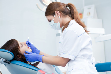 qualified dentist working in her office