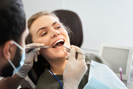 dentist examining her mouth