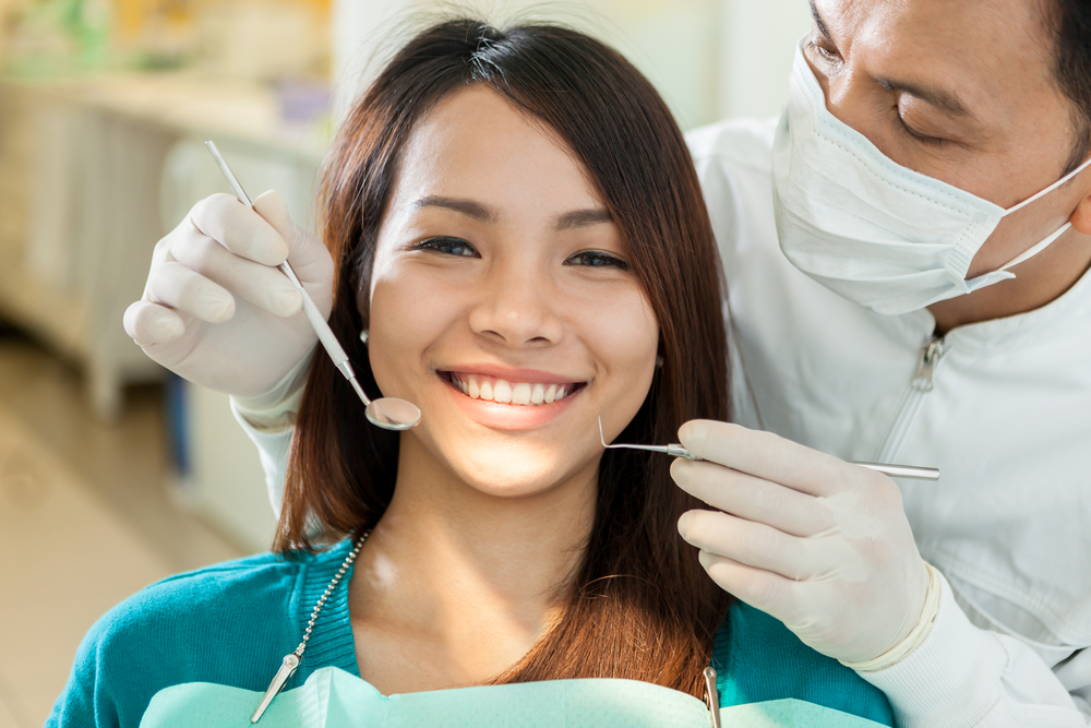 Portrait,Of,Smiling,Asian,Woman,Sitting,At,The,Dentist