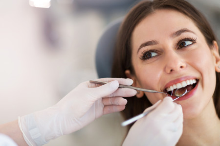 Woman having teeth examined